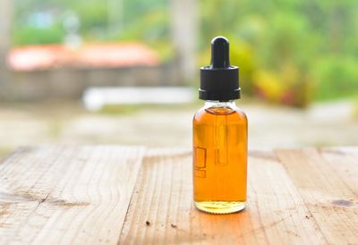 Essential oil in bottle on table