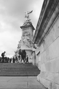 Low angle view of statue against cloudy sky