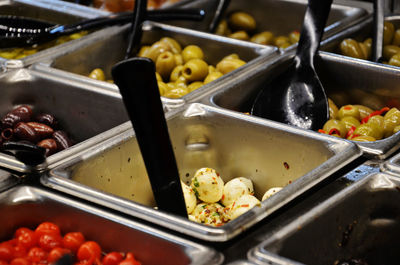 High angle view of various pickled olives for sale in store