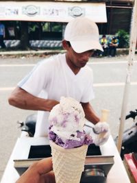 Midsection of man holding ice cream