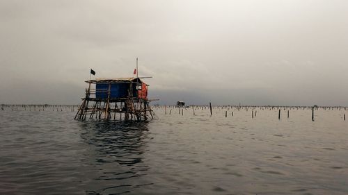 Lifeguard hut on beach against sky