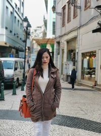 Beautiful woman walking on street in city