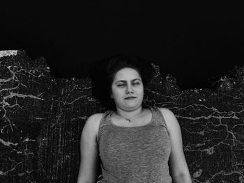 Portrait of beautiful woman standing at night