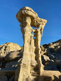 Low angle view of statue against blue sky