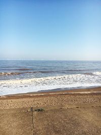 Scenic view of beach against clear sky