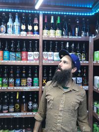 Full length of man working in bottles at store