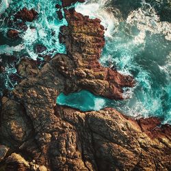 High angle view of rock formation in sea