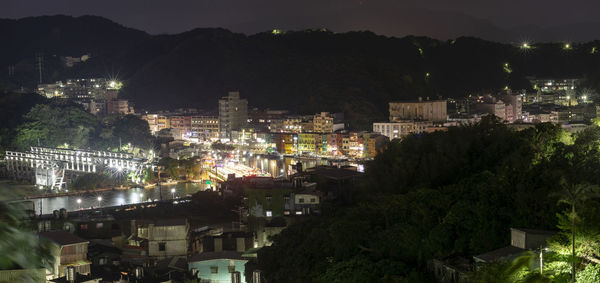 High angle view of illuminated buildings in city at night