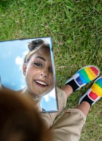 Portrait of a smiling young woman using smart phone