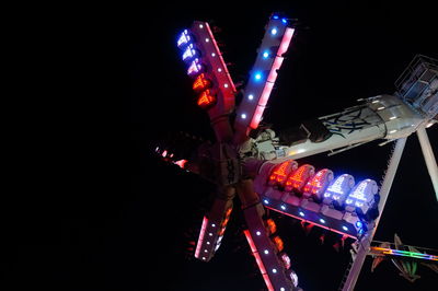 Low angle view of illuminated ferris wheel