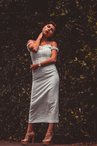 Young woman looking away while standing on land