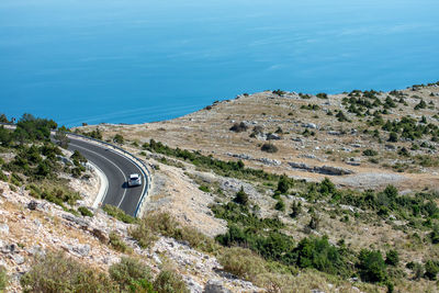 High angle view of road by sea against sky