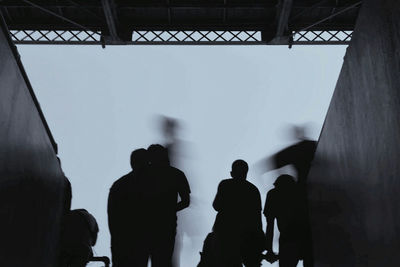 Rear view of silhouette people walking in corridor