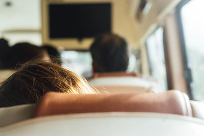 Cropped image of woman traveling in bus