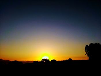 Scenic view of silhouette landscape against clear sky during sunset