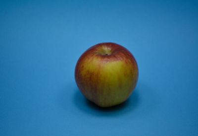 Close-up of apple against blue background