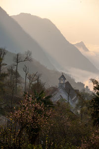 Scenic view of mountains and buildings against sky