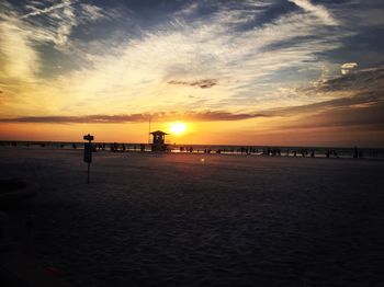 Scenic view of beach against sky during sunset