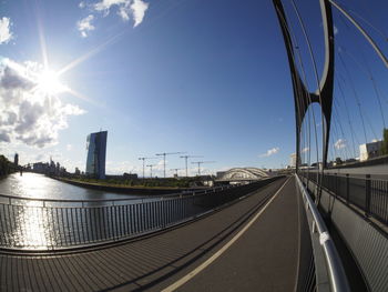 Bridge over road in city against sky