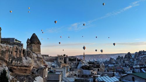 Panoramic view of buildings and city against blue sky