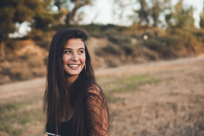 Portrait of laughing teenage girl in nature