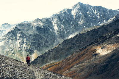 Rear view of man hiking on mountain