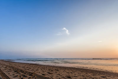 Scenic view of beach against sky during sunset