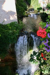 High angle view of waterfall by lake