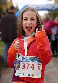 Portrait of smiling young woman holding map