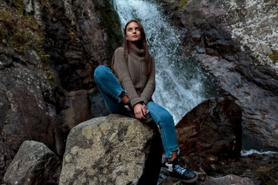 Nice girl traveler at the mistyc waterfall