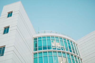 Low angle view of modern building against clear blue sky