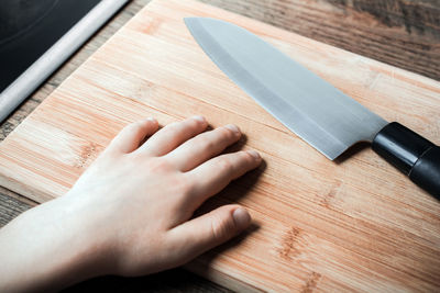 High angle view of person hand on table