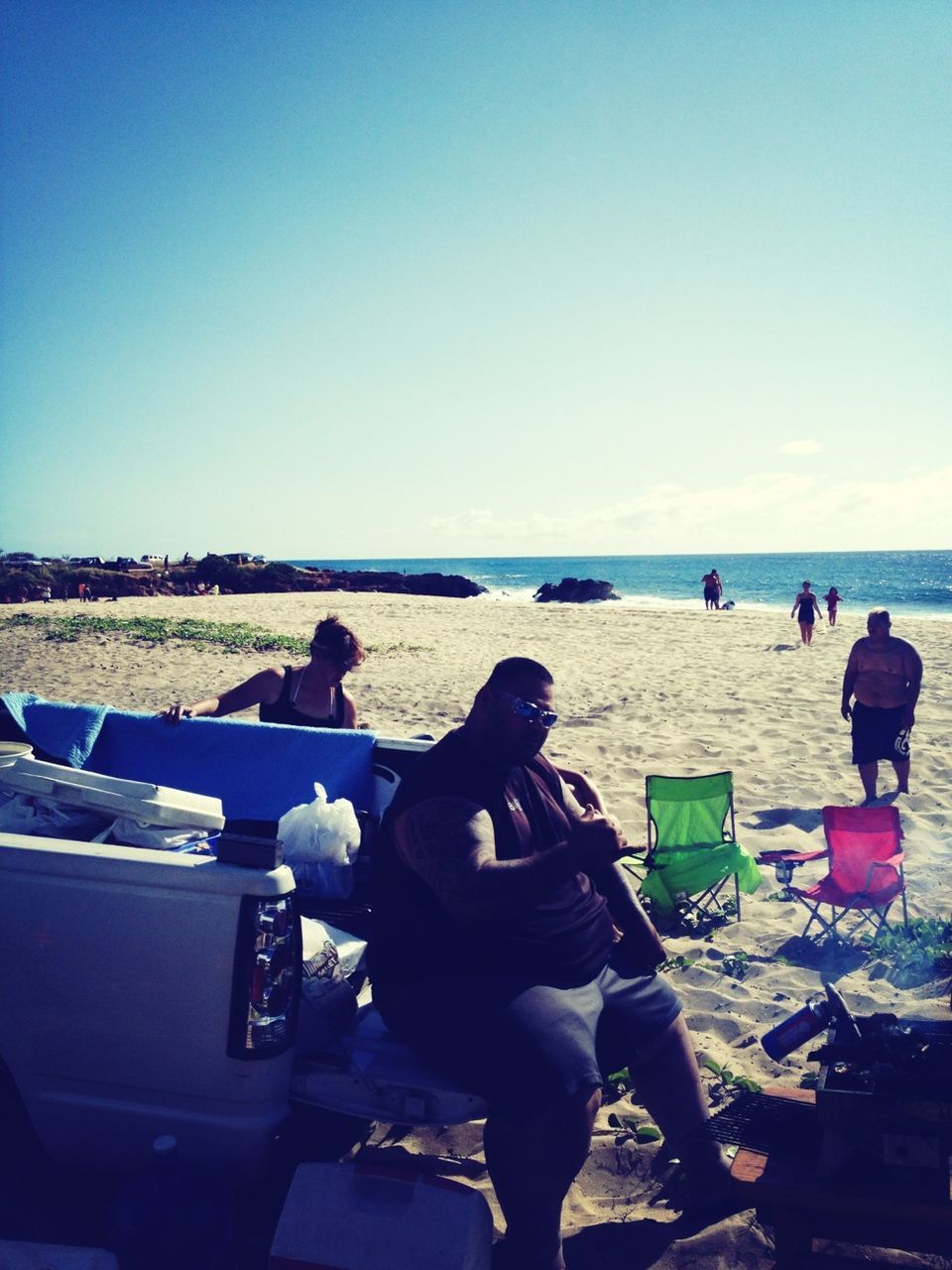 clear sky, sea, horizon over water, men, lifestyles, water, leisure activity, copy space, rear view, sitting, person, beach, blue, togetherness, relaxation, transportation, vacations