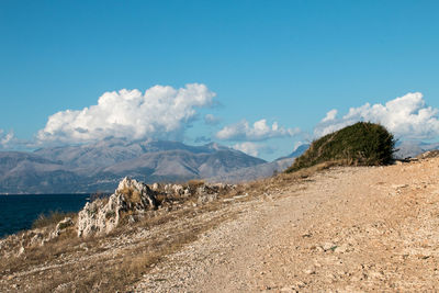 Scenic view of sea and mountains against sky