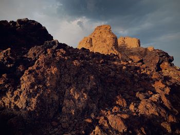 Low angle view of rocks against sky