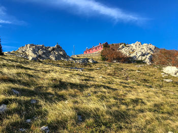 Low angle view of mountain against blue sky