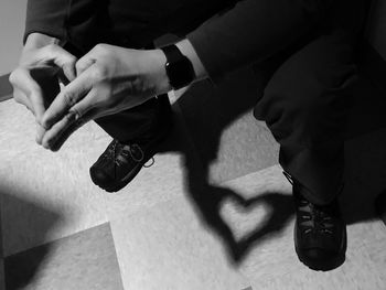 Low section of people sitting on floor