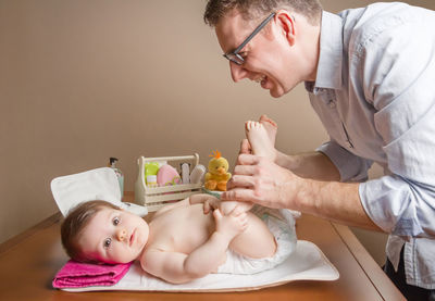 Midsection of man holding eyeglasses