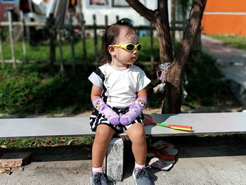 Full length of cute girl on sunglasses