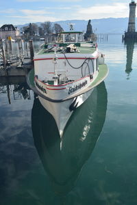 Boats moored in sea against sky