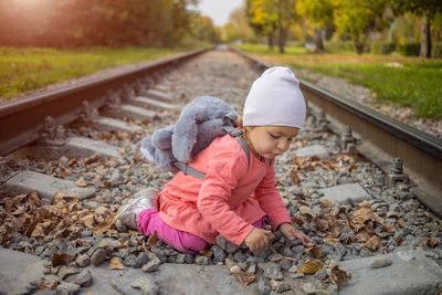 Cute girl lying on railroad track