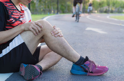 Low section of people sitting on road