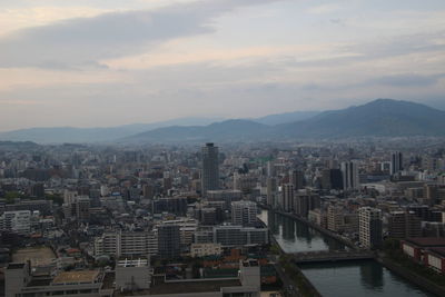 High angle view of buildings in city against sky during sunset