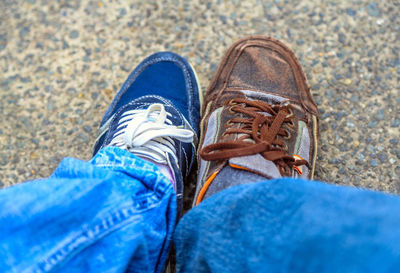 Low section of man wearing shoes