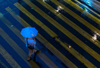 High angle view of woman walking on rainy day