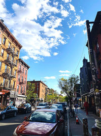 City street by buildings against sky