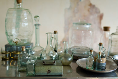 High angle view of glass bottles on table against wall