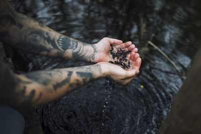 Man holding tadpoles