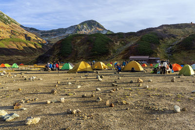 Group of people on mountain road against sky