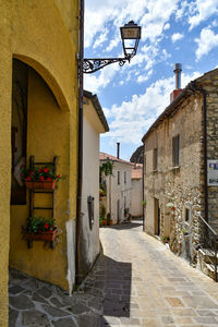 A narrow street between the old houses of sasso di castalda, a village of basilicata region, italy.